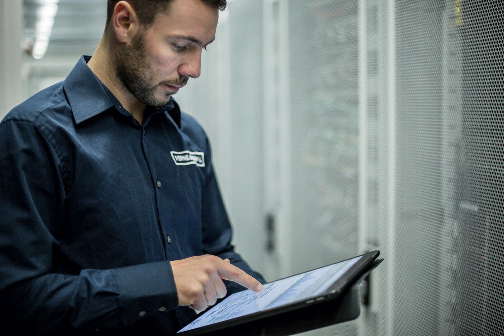 Verne engineer using a tablet in a data hall